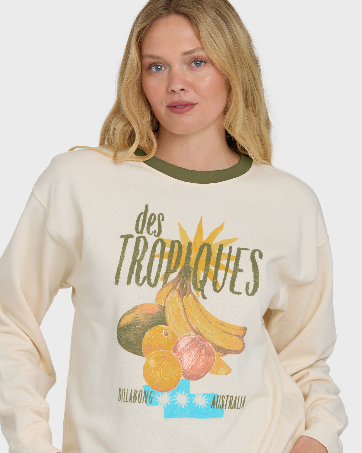 White crewneck sweatshirt with green trim and fruit graphic print featuring bananas, oranges, and avocado with text.