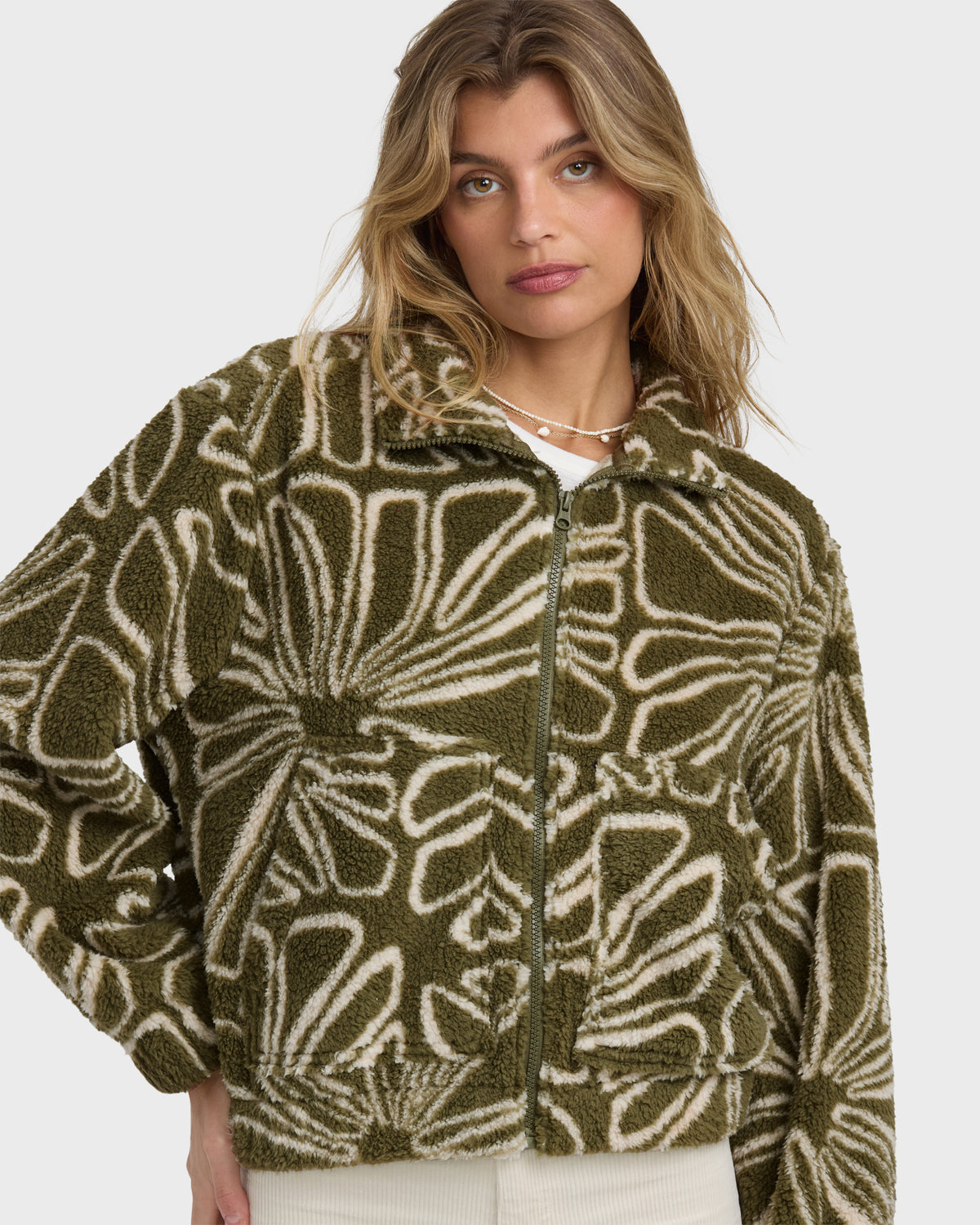 Martini olive sherpa fleece jacket with cream abstract geometric pattern and front zip closure.