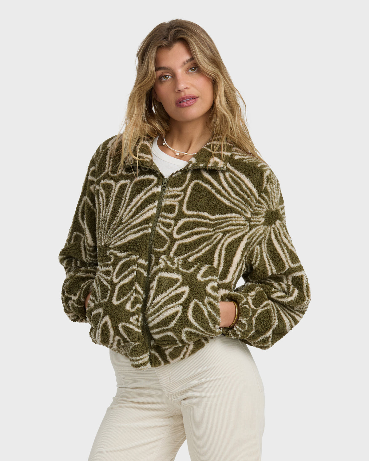 Martini olive sherpa fleece jacket with cream leaf pattern, front zip closure, and patch pockets worn over white shirt.