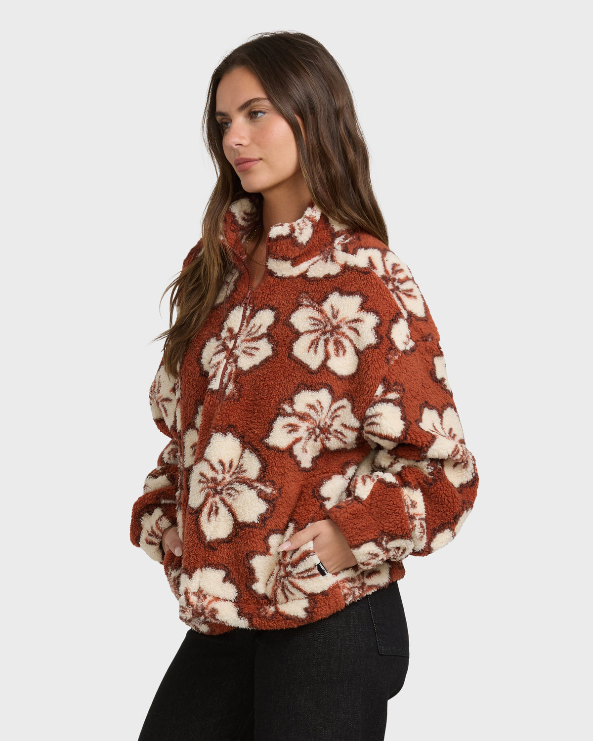 Sedona sherpa half zip sweatshirt with cream floral pattern, worn with black pants.