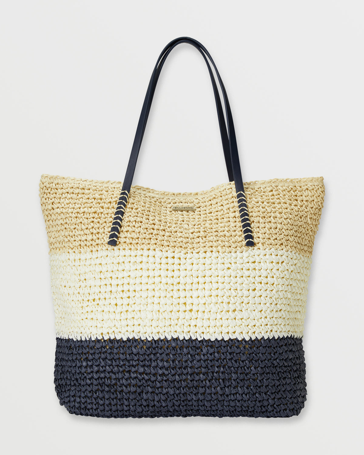 Black and cream woven straw tote bag with black handles and horizontal color blocking stripes.