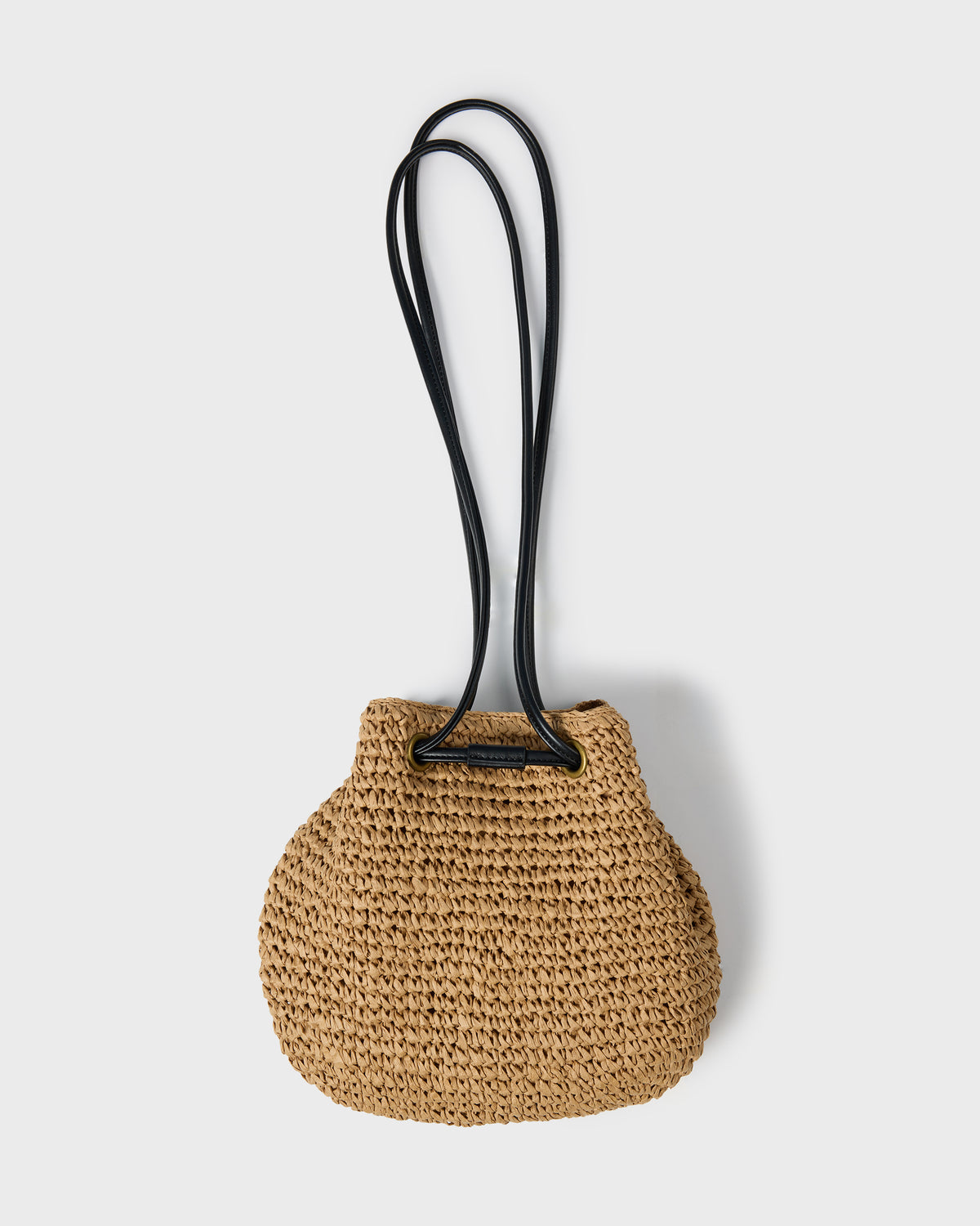 Tan woven straw mini tote bag with black crossbody straps.