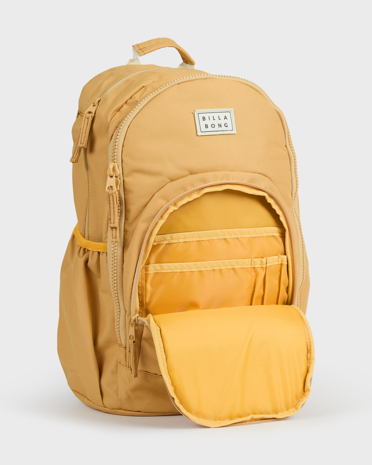 Honey-colored Roadie backpack with top handle, front logo patch, and open main compartment revealing yellow interior with mul