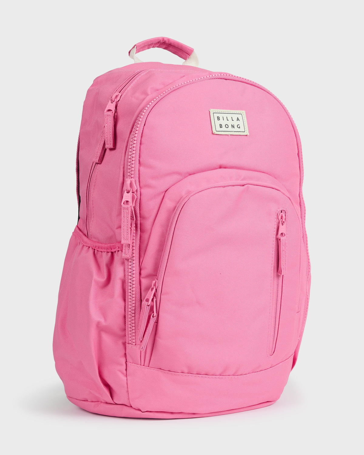 Pink Billabong Roadie backpack with padded straps, front zip pocket, and branded label.