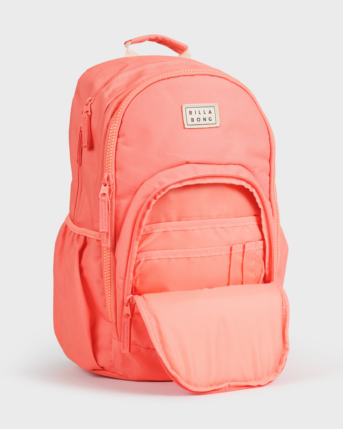 Papaya-colored Billabong Roadie backpack with top handle, front zippered pockets, and open main compartment.