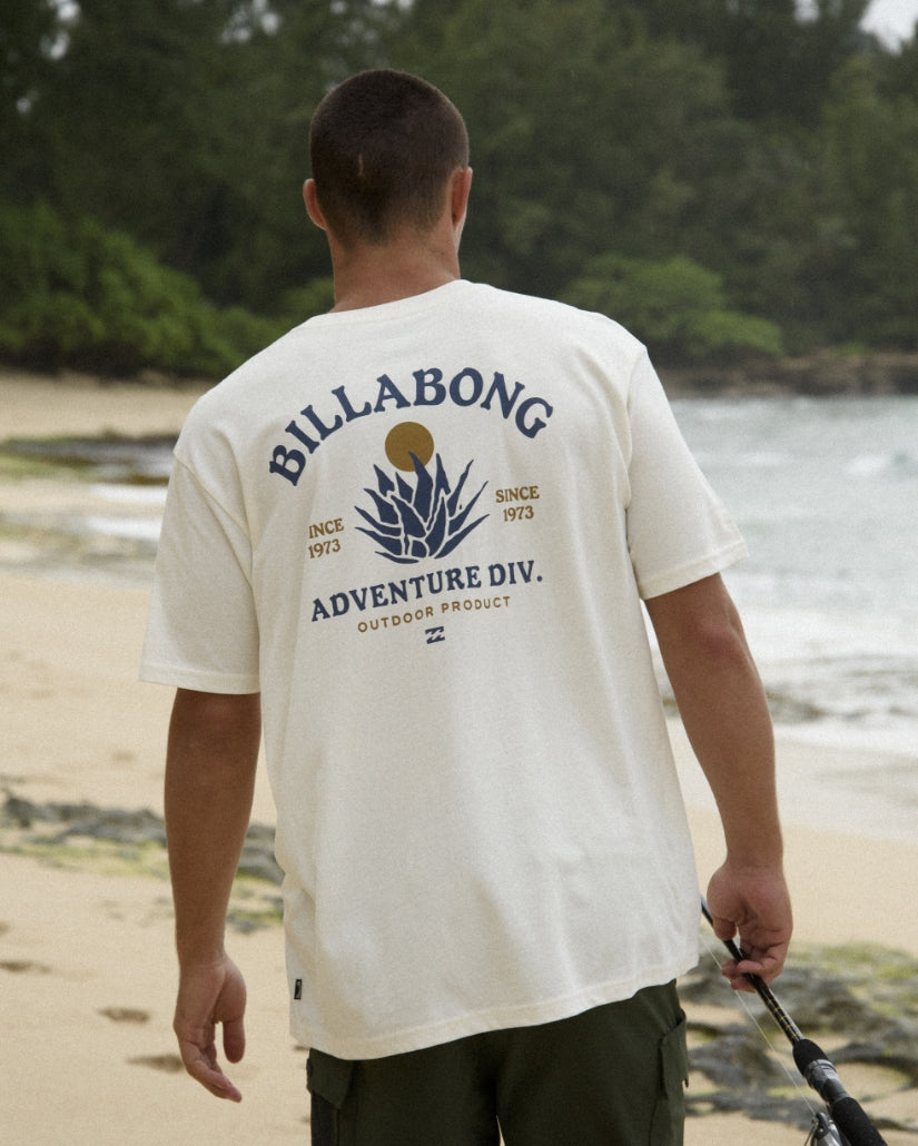 Off-white short-sleeve tee with Billabong Adventure Div. agave graphic and text printed on back.