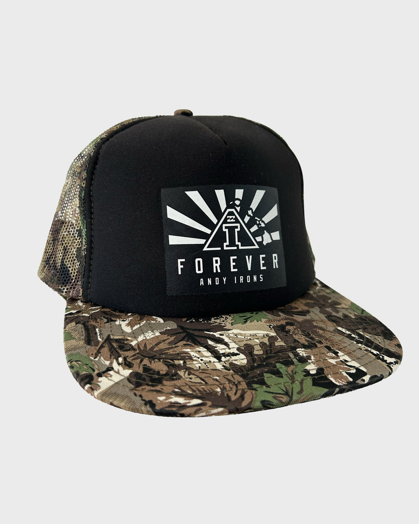 Black trucker hat with camouflage bill, mesh back panel, and white "Forever Andy Irons" graphic on front.