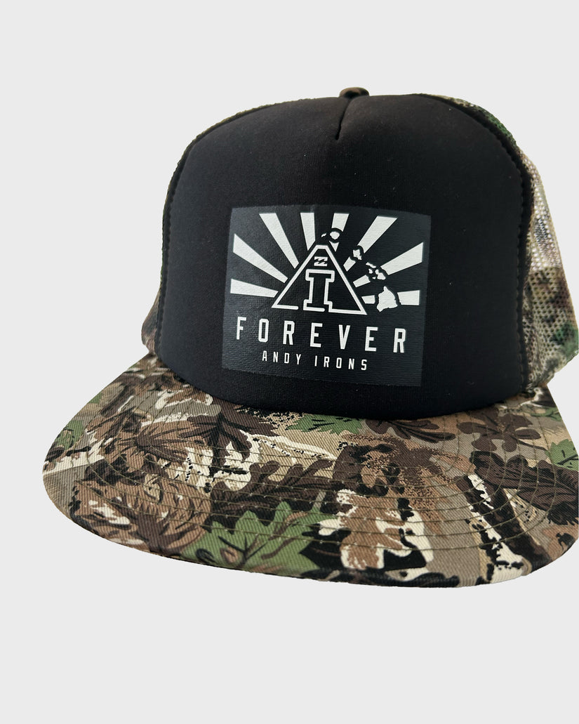 Black and camouflage trucker hat with "Forever Andy Irons" graphic featuring a triangle logo and radiating lines on front pan