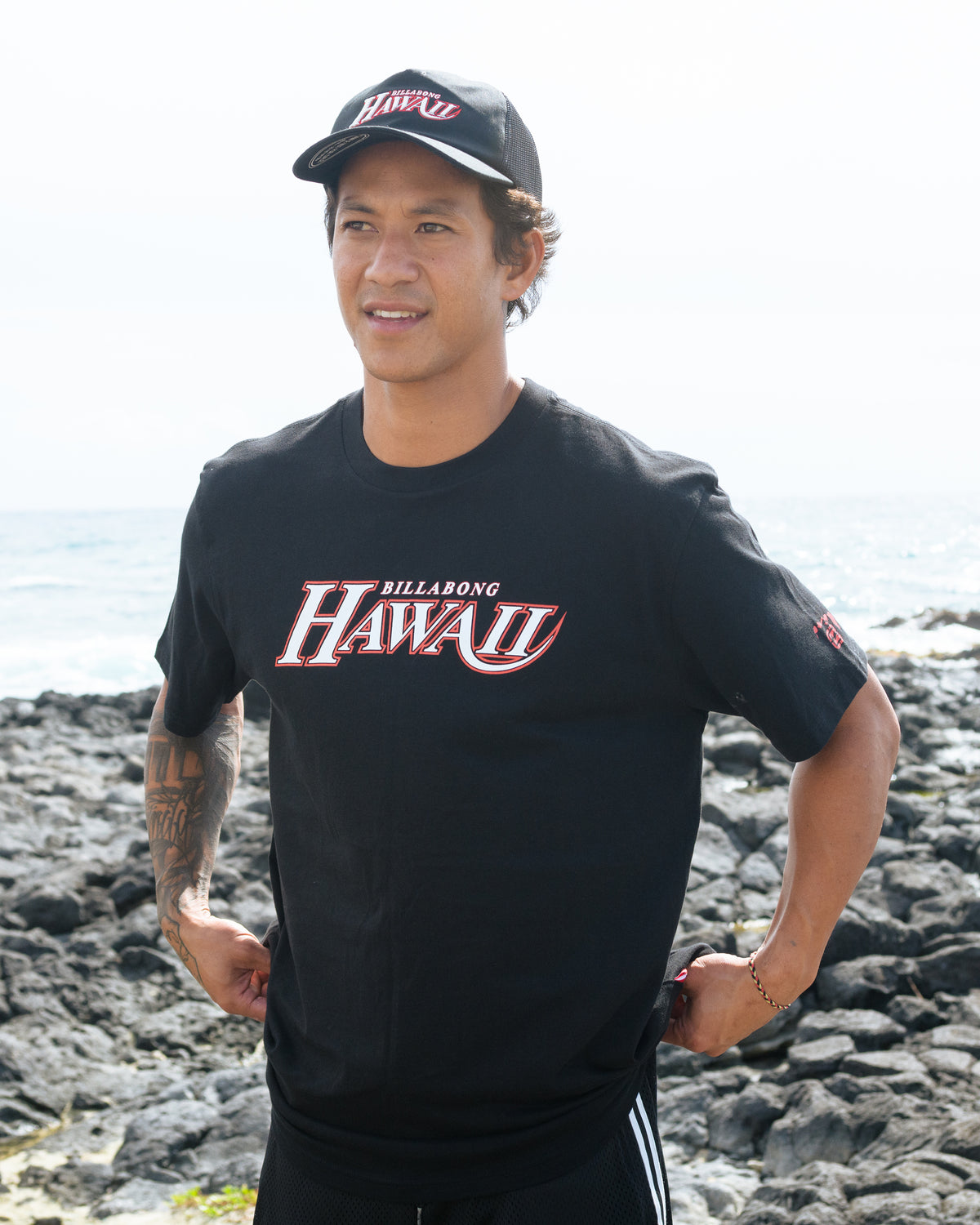 Black short sleeve t-shirt with red and white "Billabong Hawaii" graphic on chest.