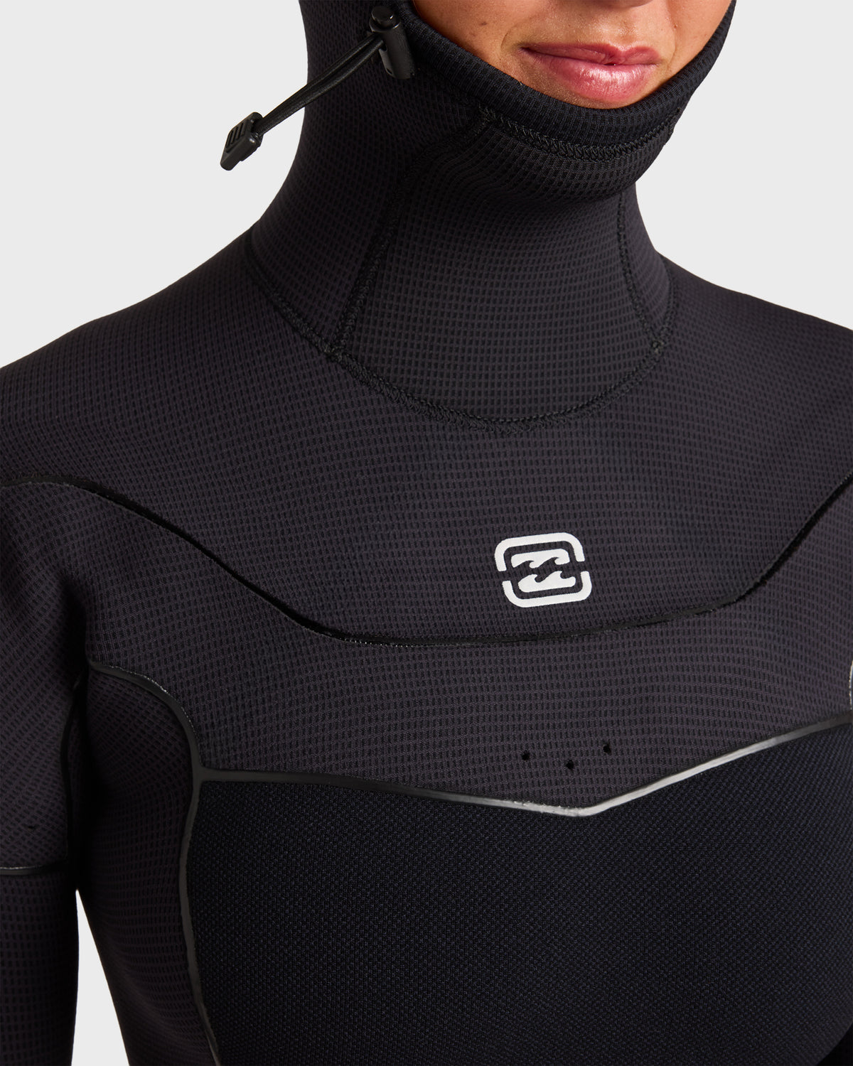 Black full wetsuit with hooded chest zip collar and textured neoprene material shown on model.