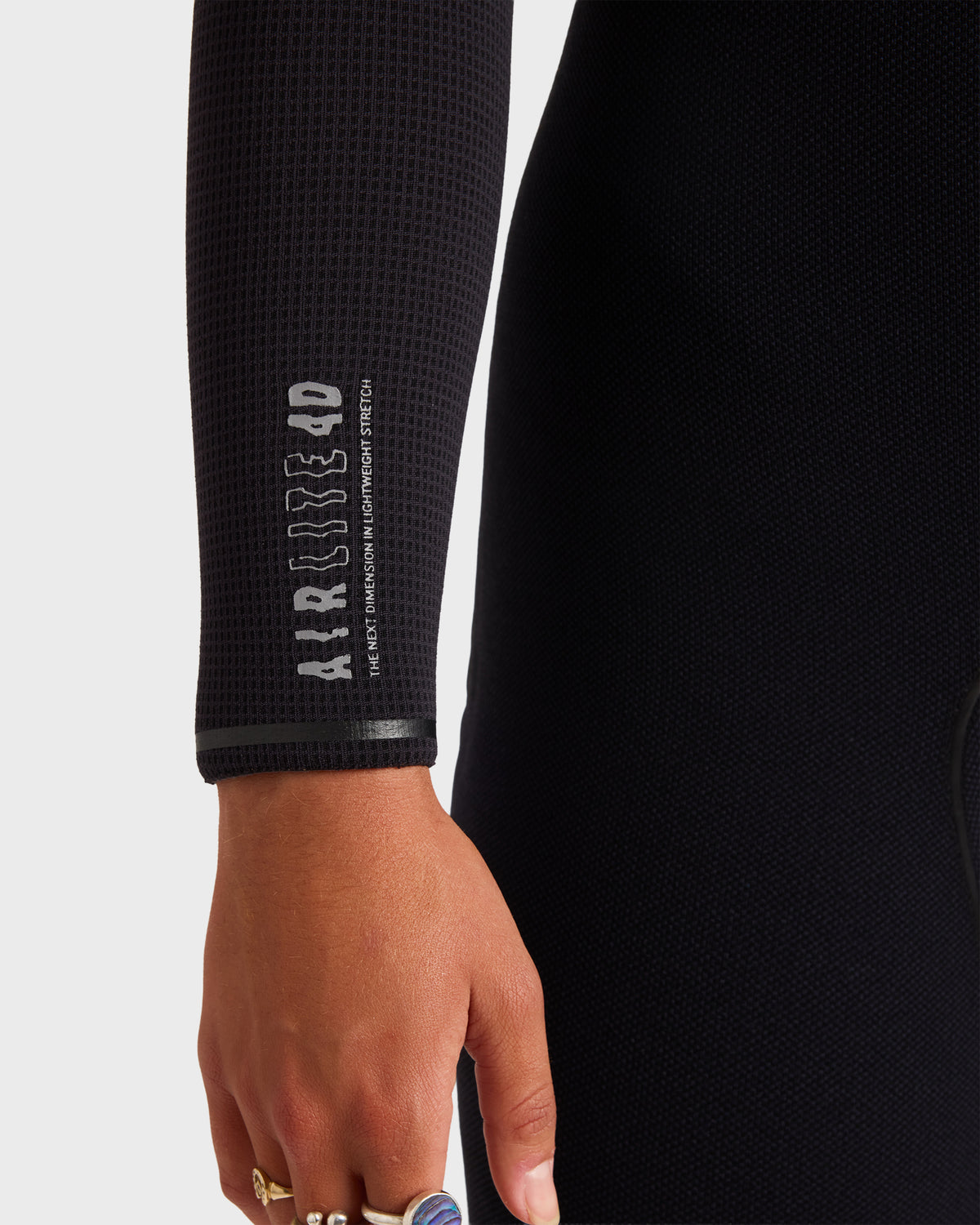 Black hooded chest zip full wetsuit sleeve with textured neoprene material and branded text on wrist.
