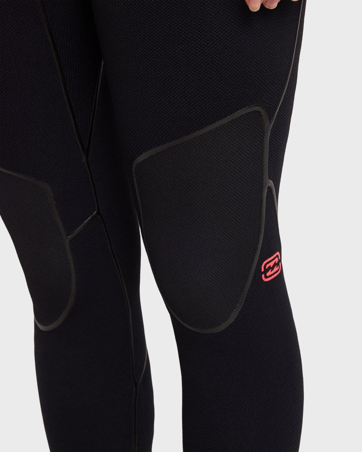 Black full-length wetsuit with hooded chest zip, textured neoprene material, and red brand logo on thigh.