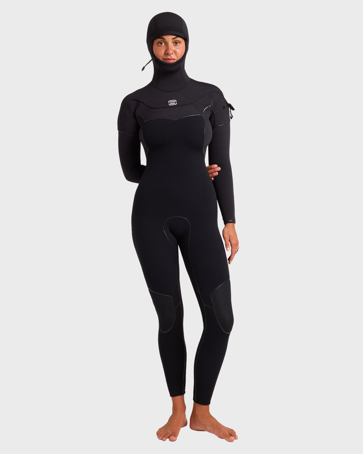 Black full-length wetsuit with attached hood, chest zip, and long sleeves on model.