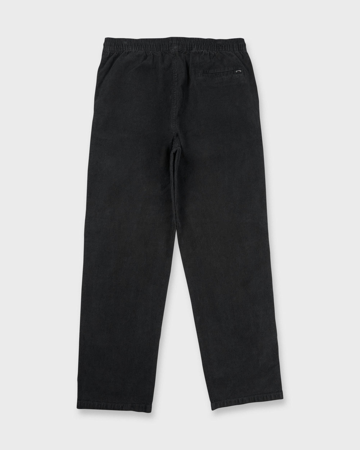 Washed black corduroy pants with elastic waistband and back pocket, shown from behind.