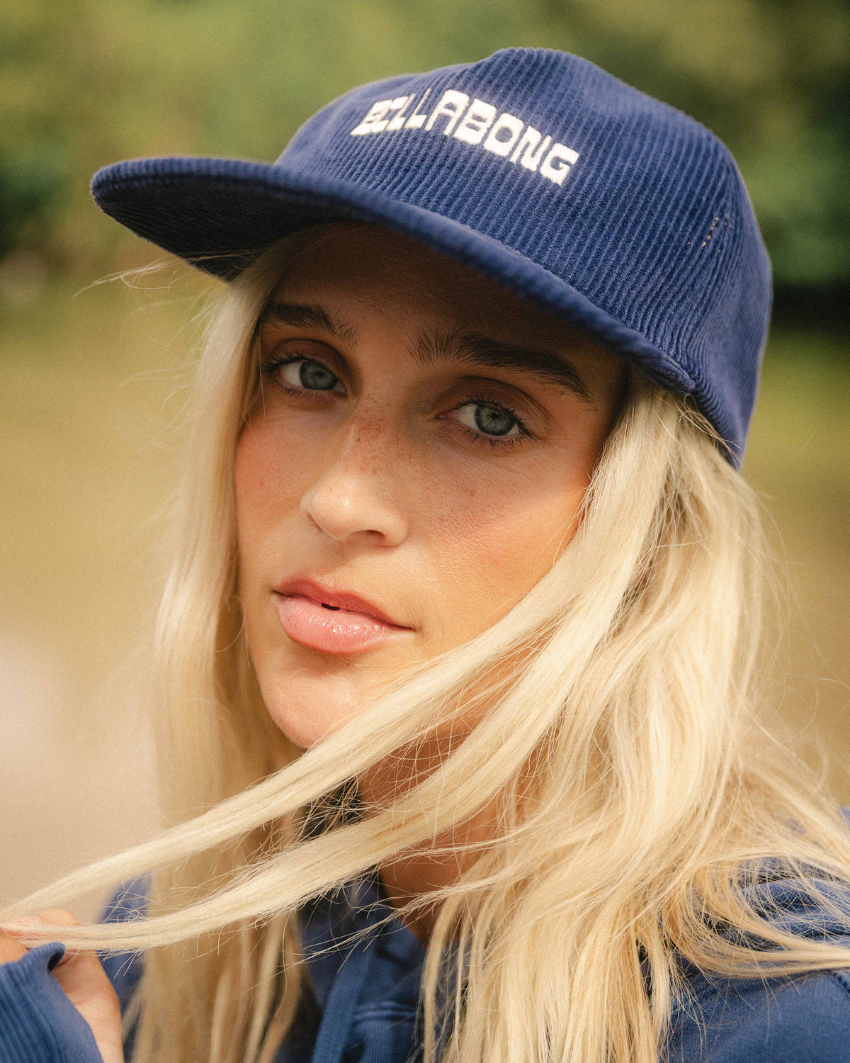 Celestial blue corduroy grandpa hat with white embroidered text on front and curved brim.