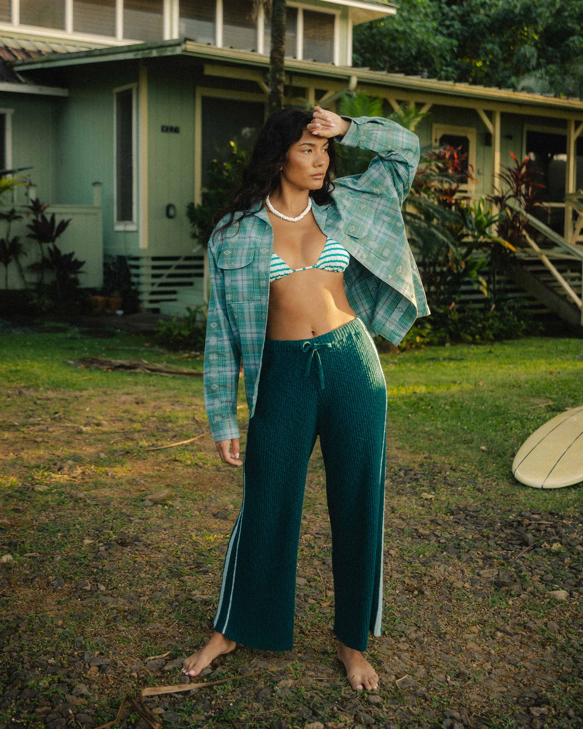 Spruce green ribbed sweaterpants with drawstring waist and wide legs, worn with matching striped shirt.