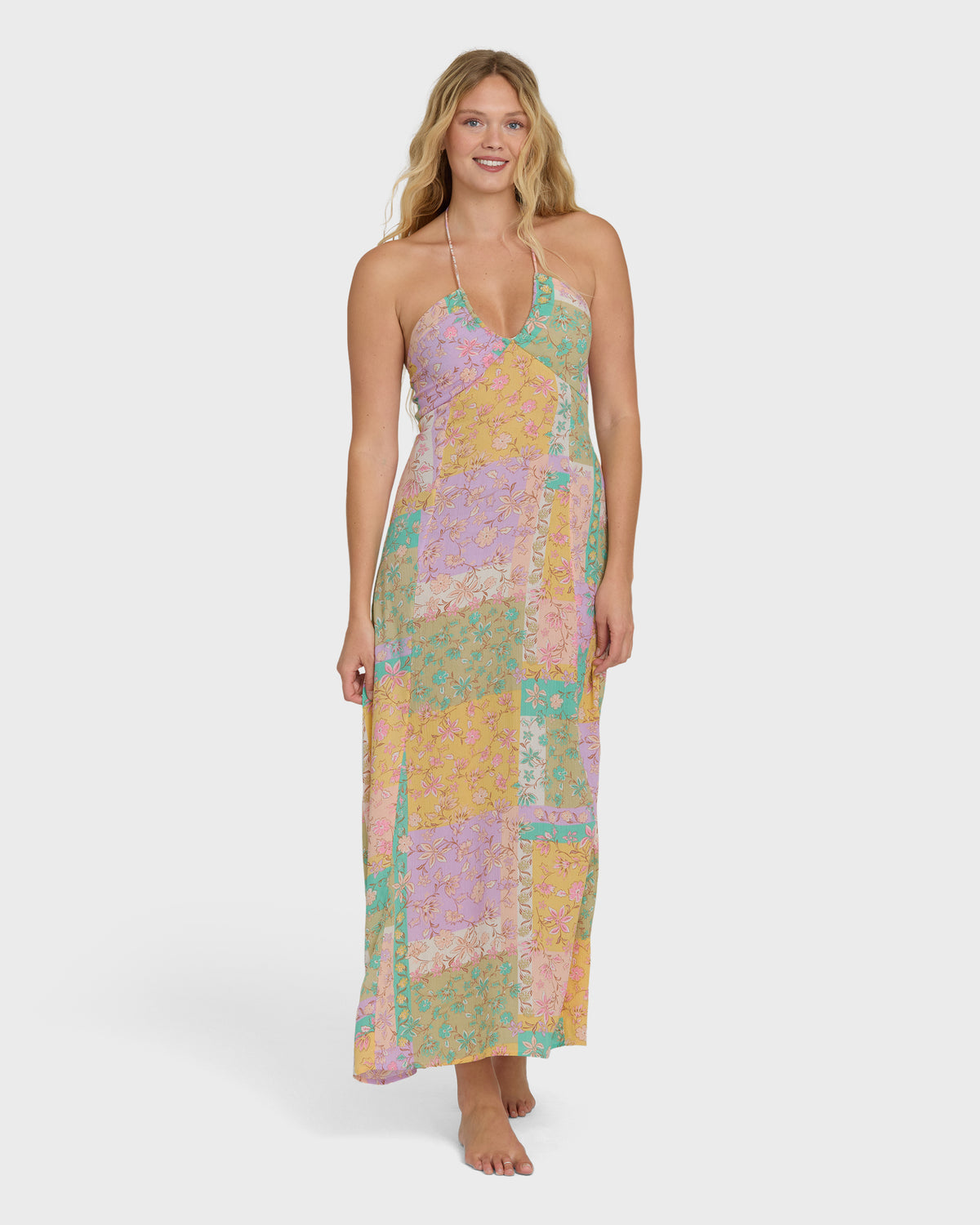 Halter maxi dress in patchwork print with violet, yellow, and teal colored blocks.