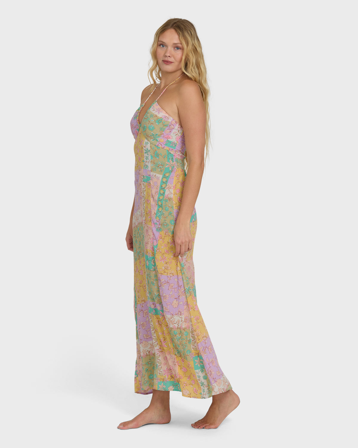 Violet maxi dress with multicolored floral patchwork pattern and halter neckline on model.