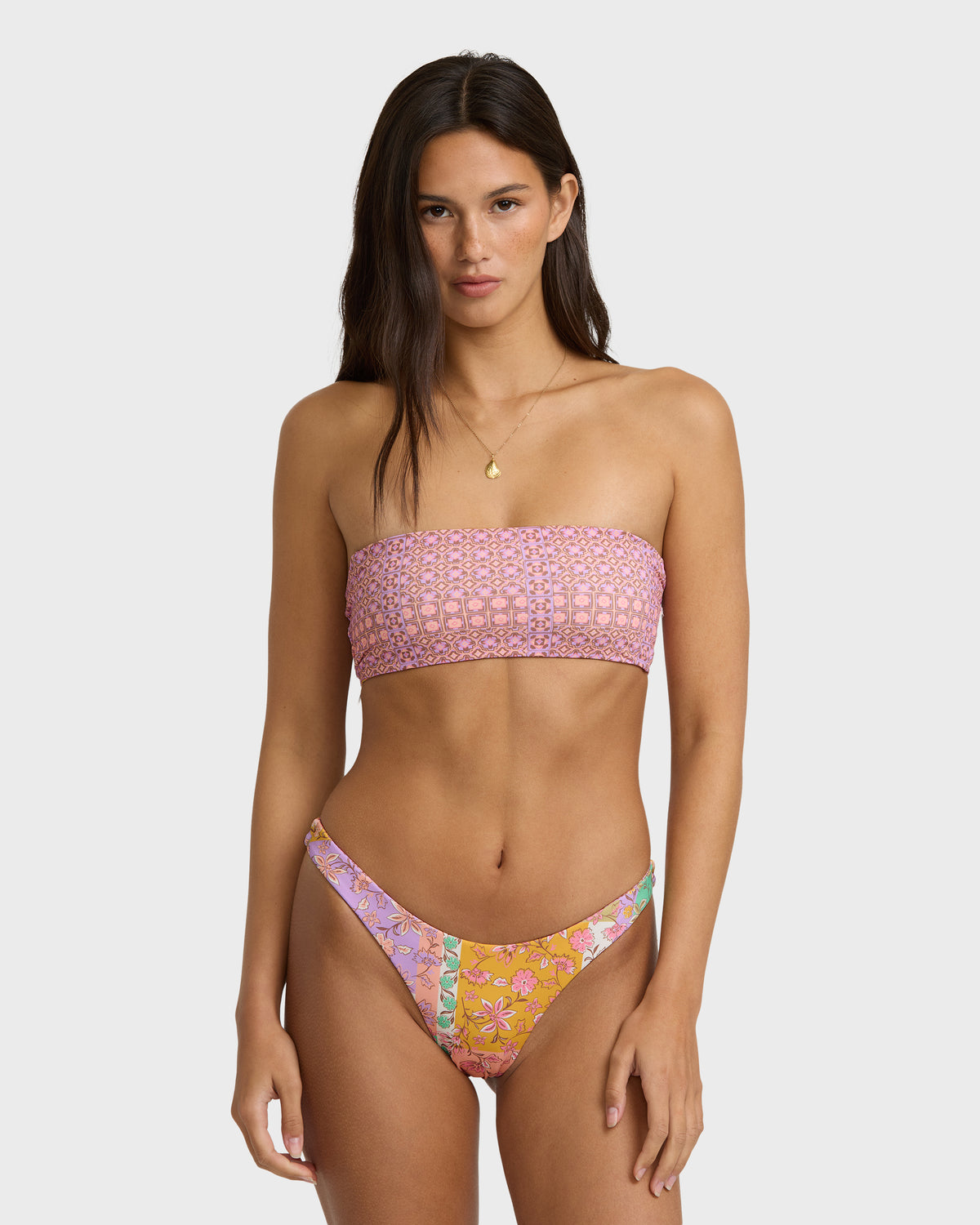 Lilac bandeau bikini top with textured pattern, shown on model with matching reversible bottoms featuring floral print.