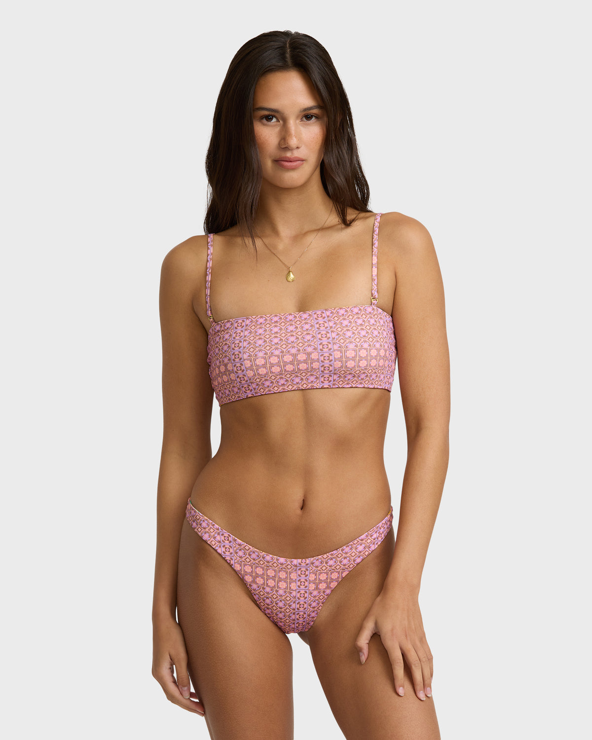 Lilac bandeau bikini top with geometric pattern and adjustable straps on model.