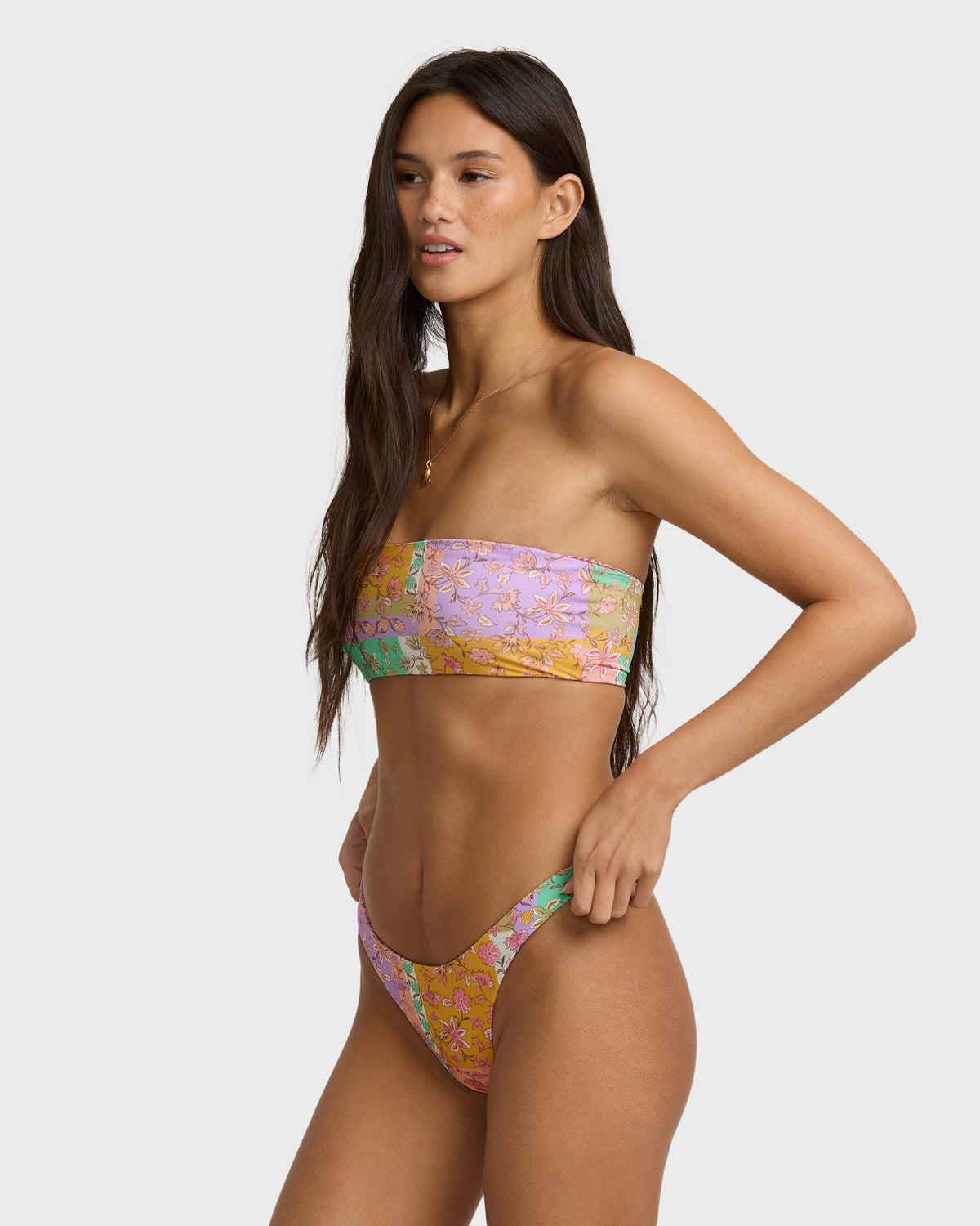 Lilac bandeau bikini top with reversible floral and solid pattern, shown on model as two-piece set.