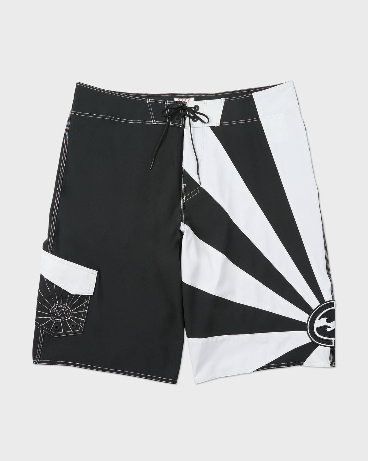 Black and white colorblock board shorts with drawstring waist, cargo pocket, and geometric sun logo design.