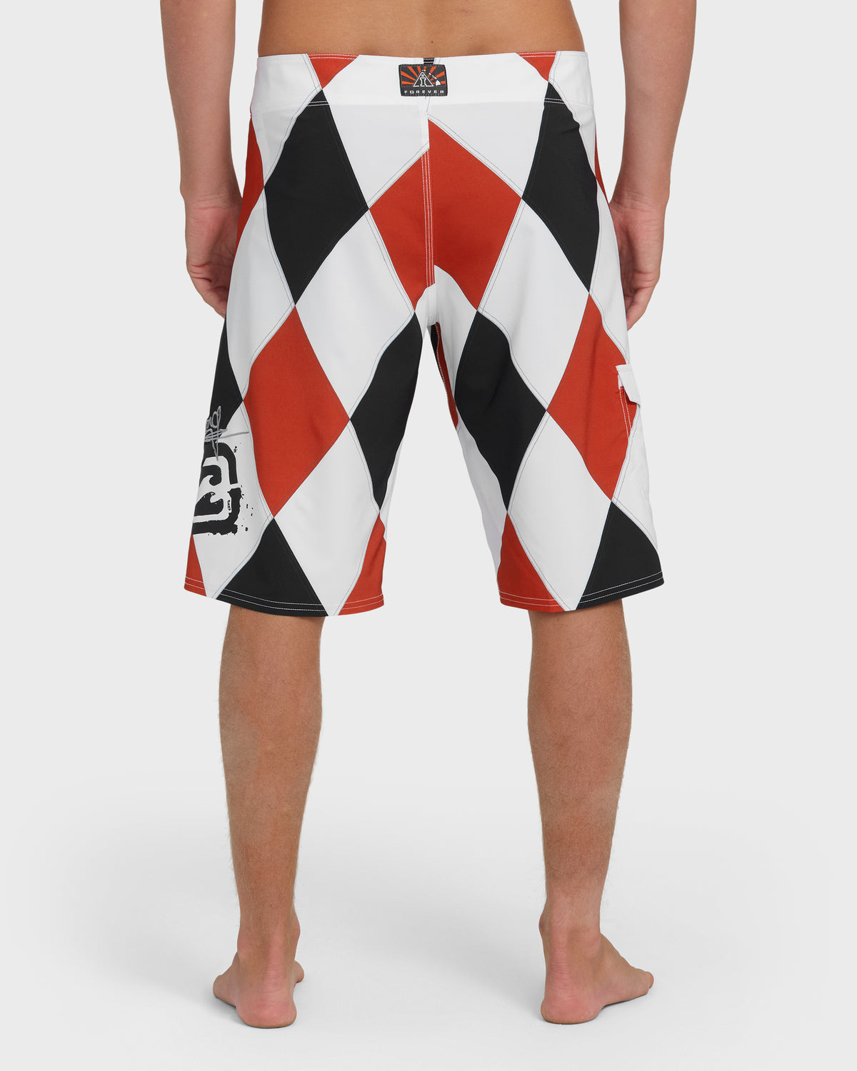 Red, white, and black diamond pattern boardshorts with branded waistband label, shown from back view.