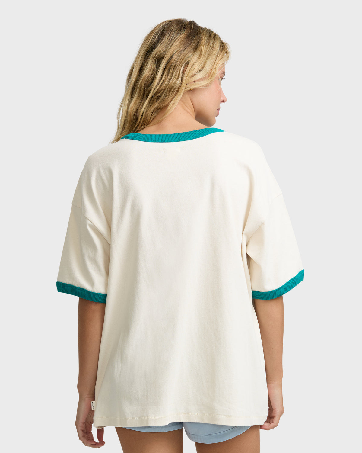 White short-sleeve t-shirt with teal ringer trim at neckline and cuffs, shown from back.