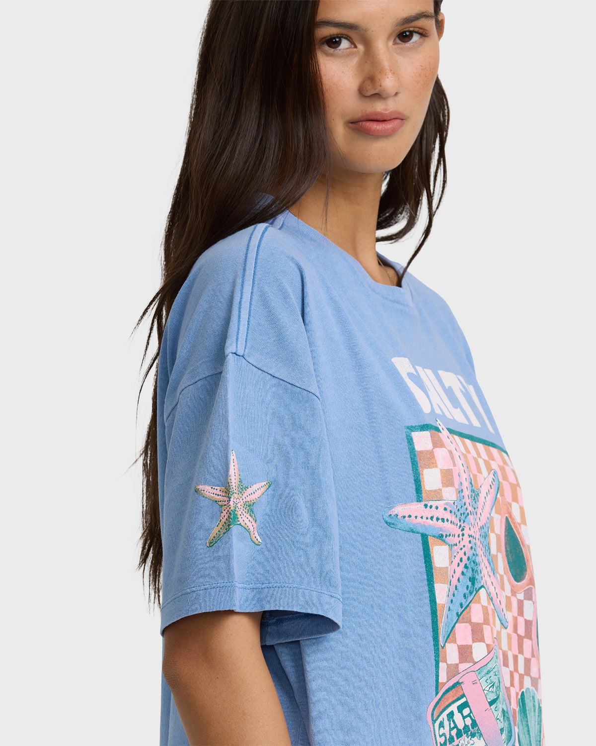 Blue short-sleeve cotton t-shirt with "Salty Life" graphic and colorful starfish and checkered design.