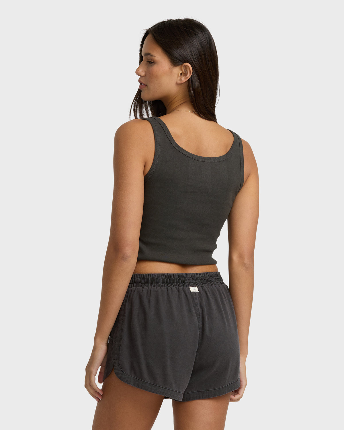 Off-black sleeveless tank top with round neckline, shown on model from behind.