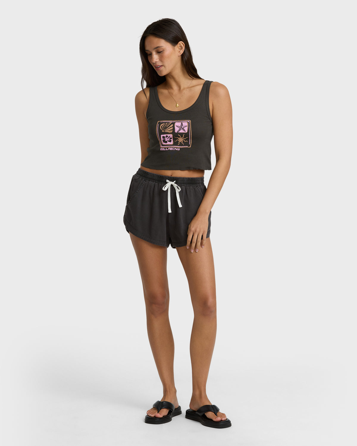 Off-black sleeveless crop tank top with colorful graphic design and matching drawstring shorts.