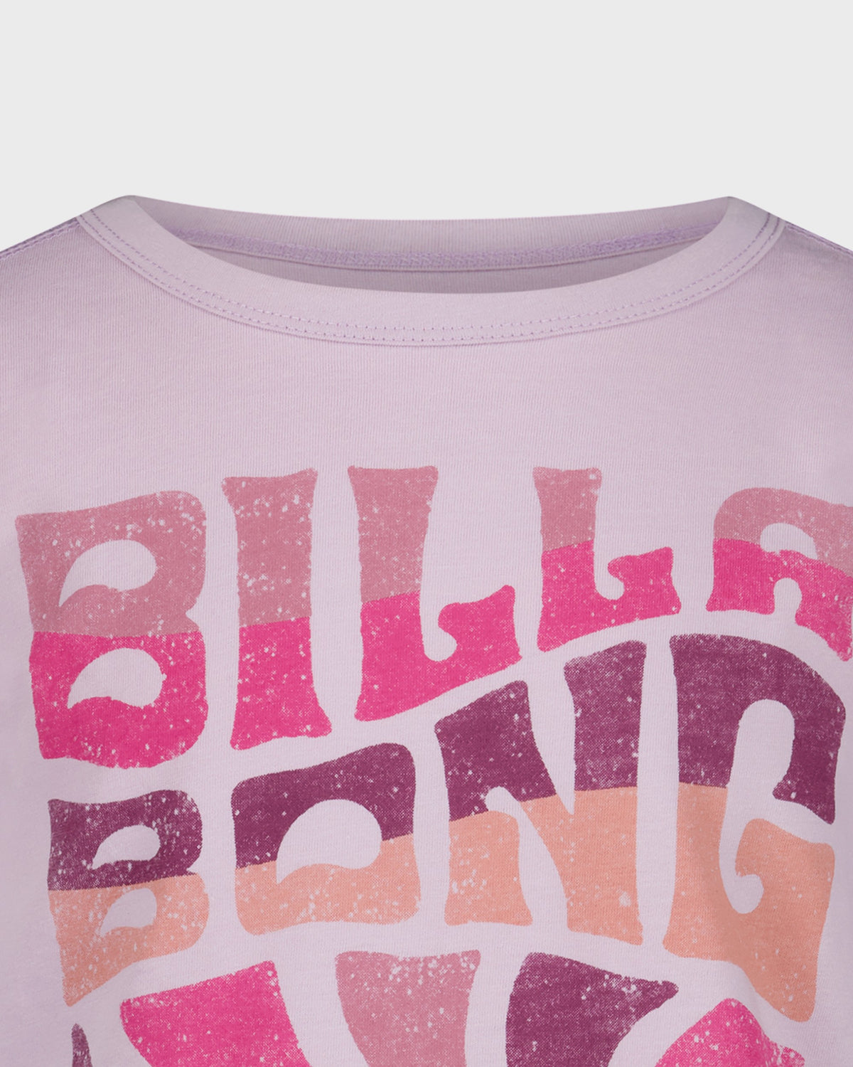 Close-up of a shirt with 'Billabong' logo in pink and purple gradient on a light purple background