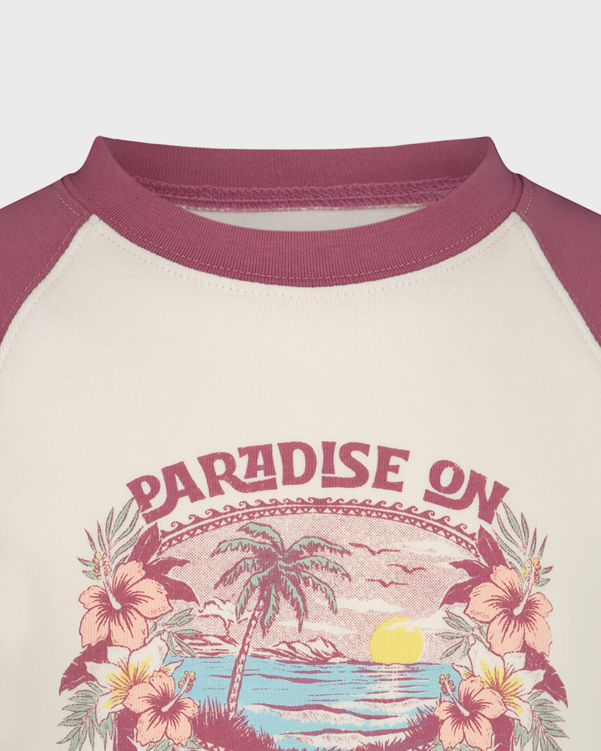 Children's shirt with 'Paradise On' design featuring a palm tree and flowers on a beige background.
