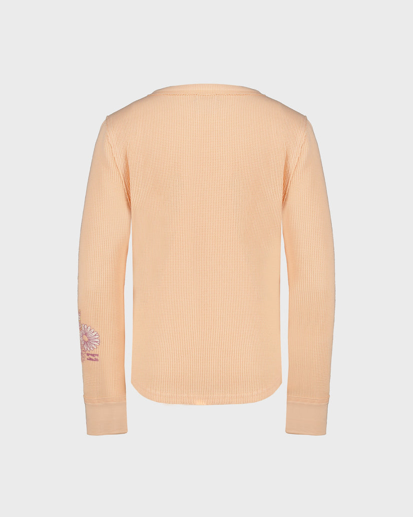 Beige ribbed sweater with a small logo on the sleeve against a light gray background