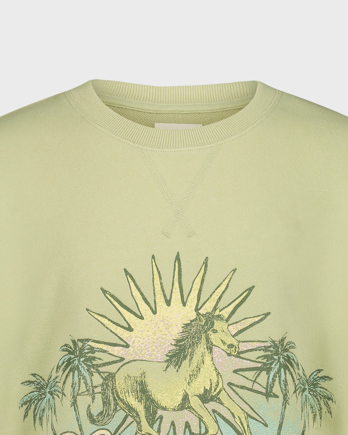 Light green sweatshirt with a unicorn and palm tree design on a white background