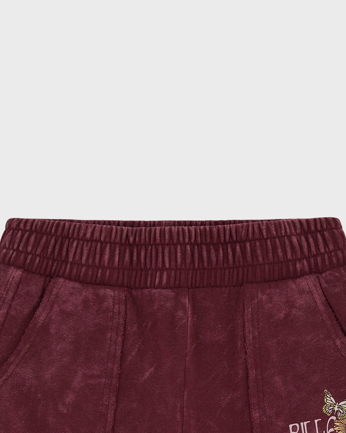 Burgundy wide leg pants with elastic waistband and decorative embroidery detail at hem.