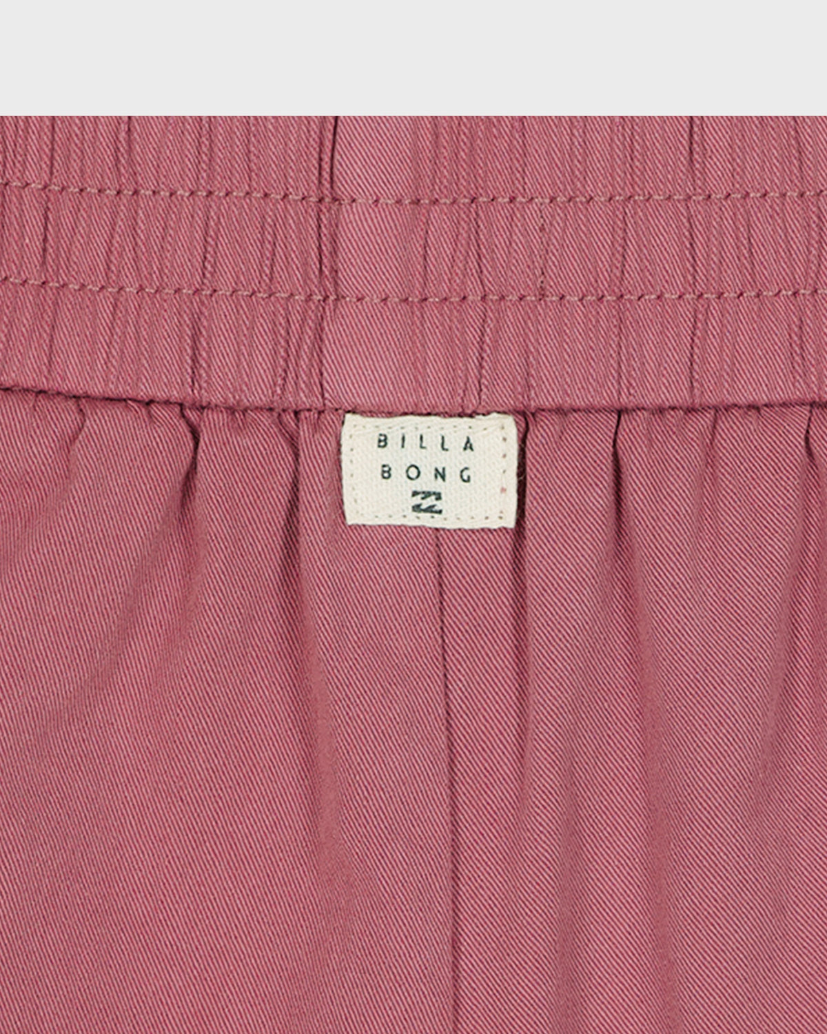 Close-up of pink shorts with Billabong label