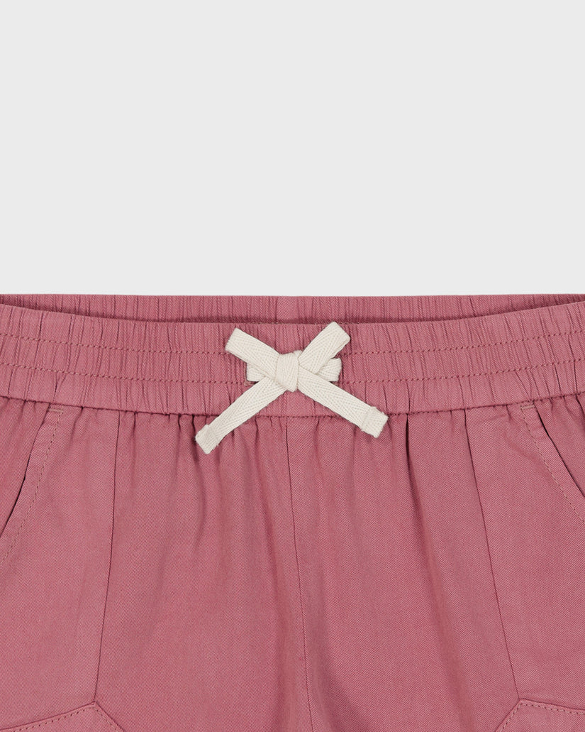 Pink shorts with a white drawstring on a light gray background