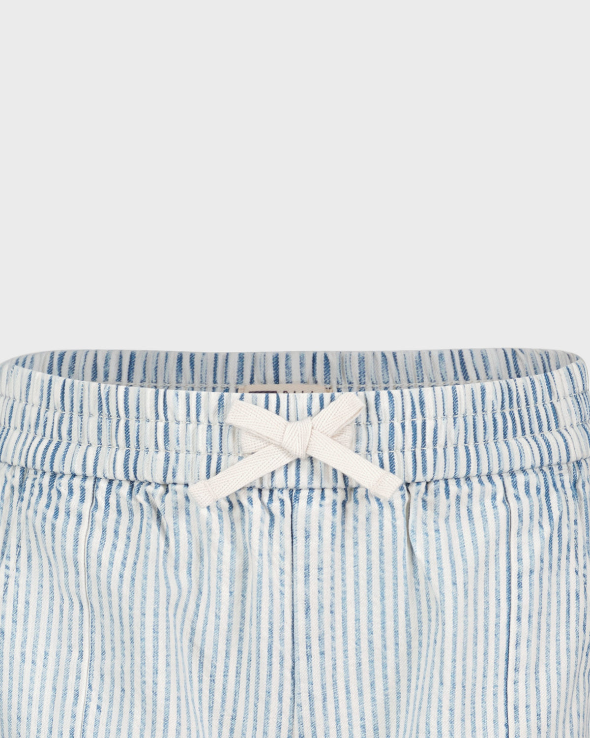Blue and white striped shorts with a white bow on a light gray background