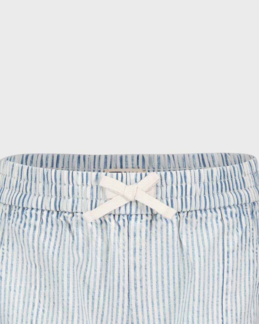 Blue and white striped shorts with a white bow on a light gray background