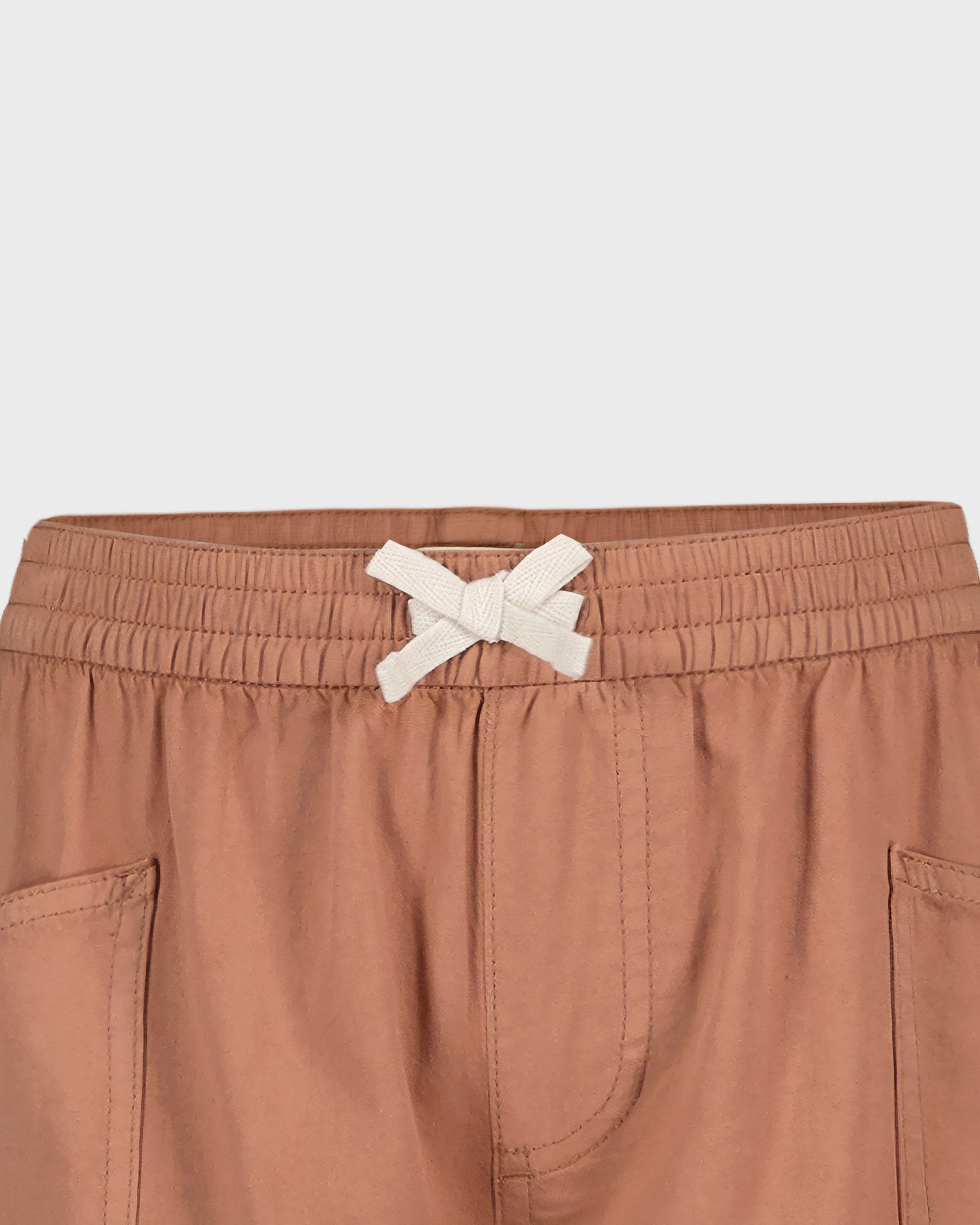 Brown shorts with a white drawstring on a light gray background