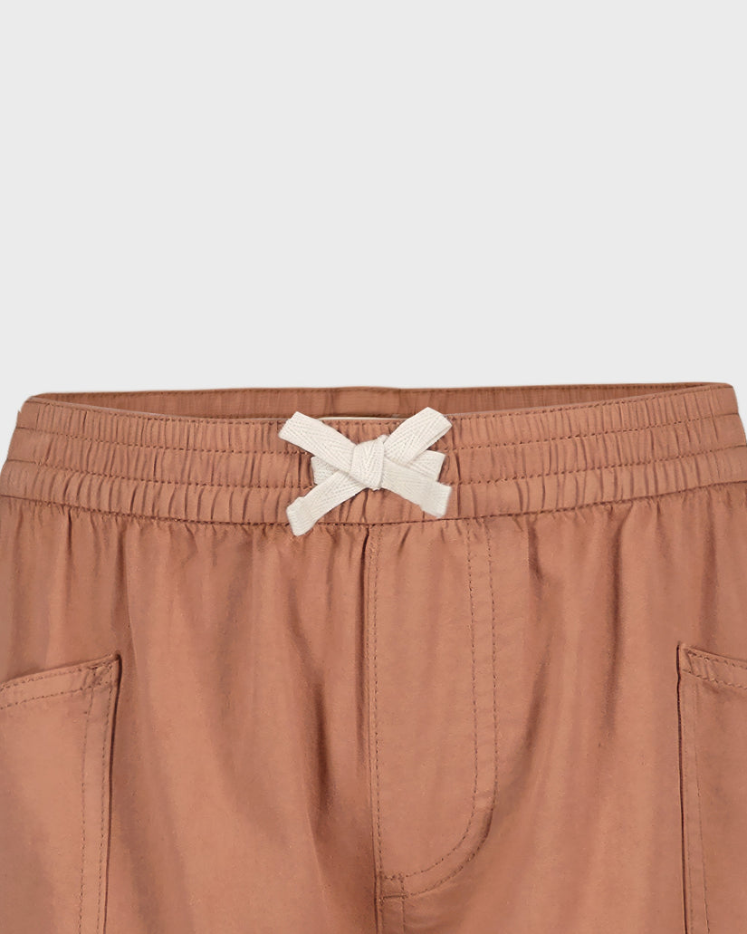 Brown shorts with a white drawstring on a light gray background