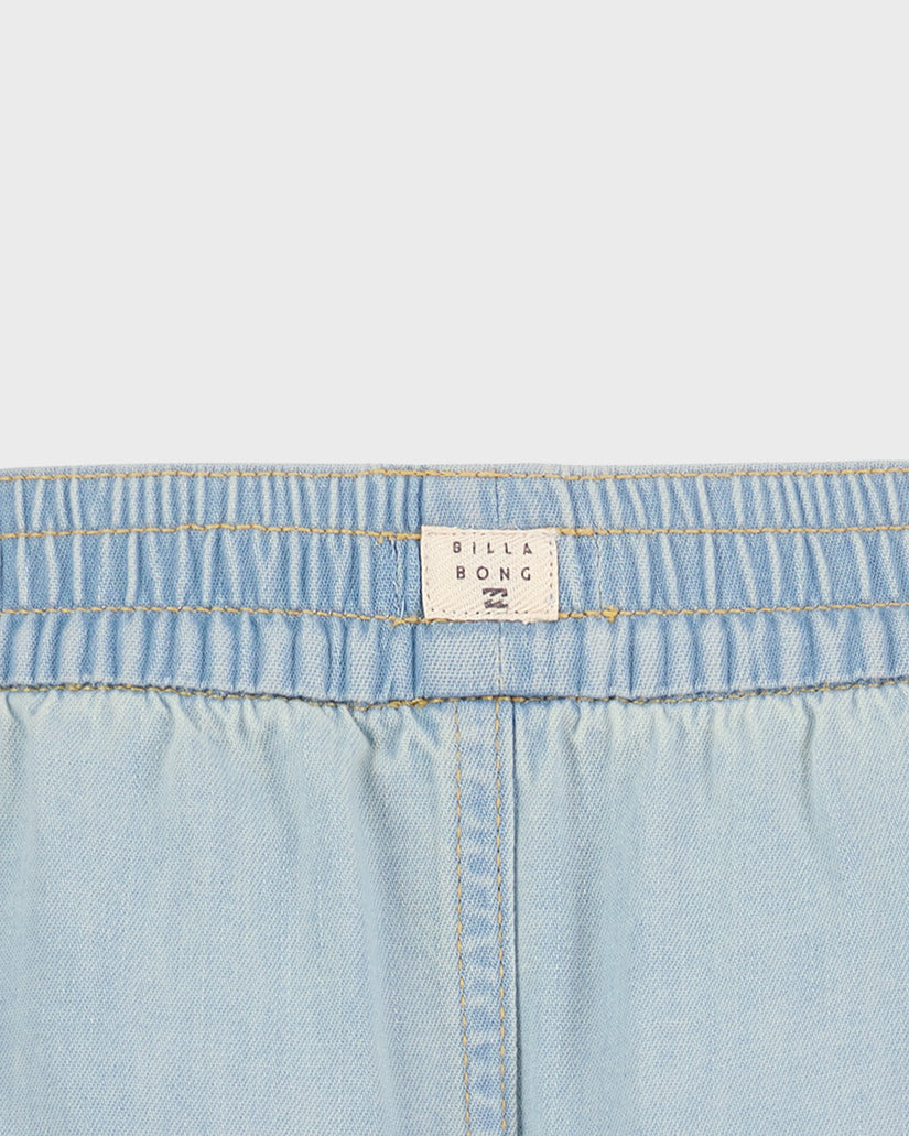 Close-up of light blue denim fabric with a Billabong label.