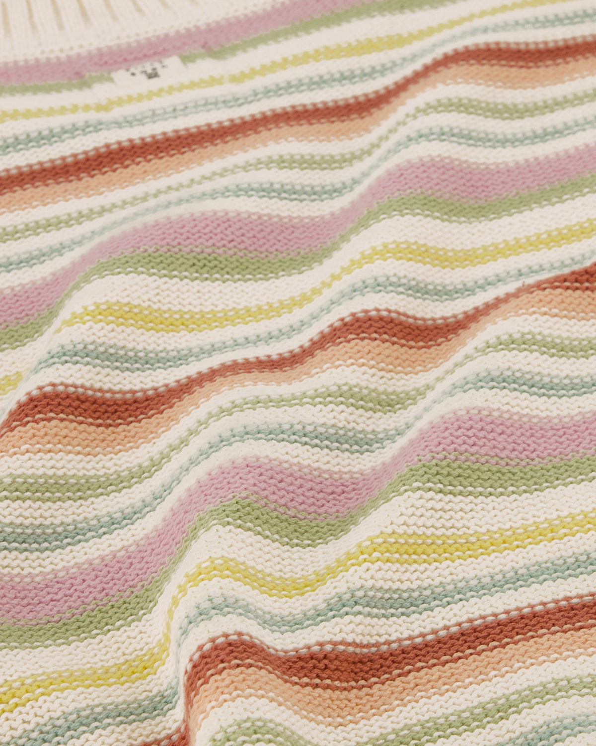 Close-up of a textured fabric with wavy multicolored stripes.