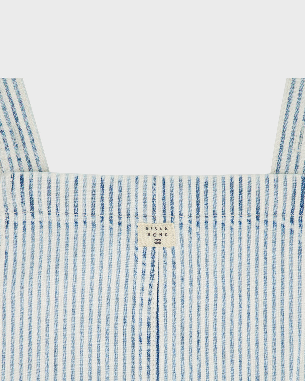 Close-up of a blue and white striped garment with a brand label on a light gray background