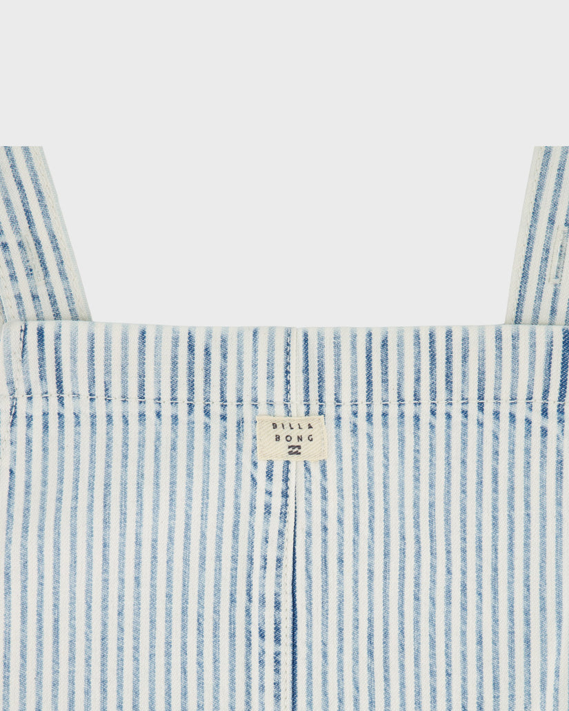 Close-up of a blue and white striped garment with a brand label on a light gray background