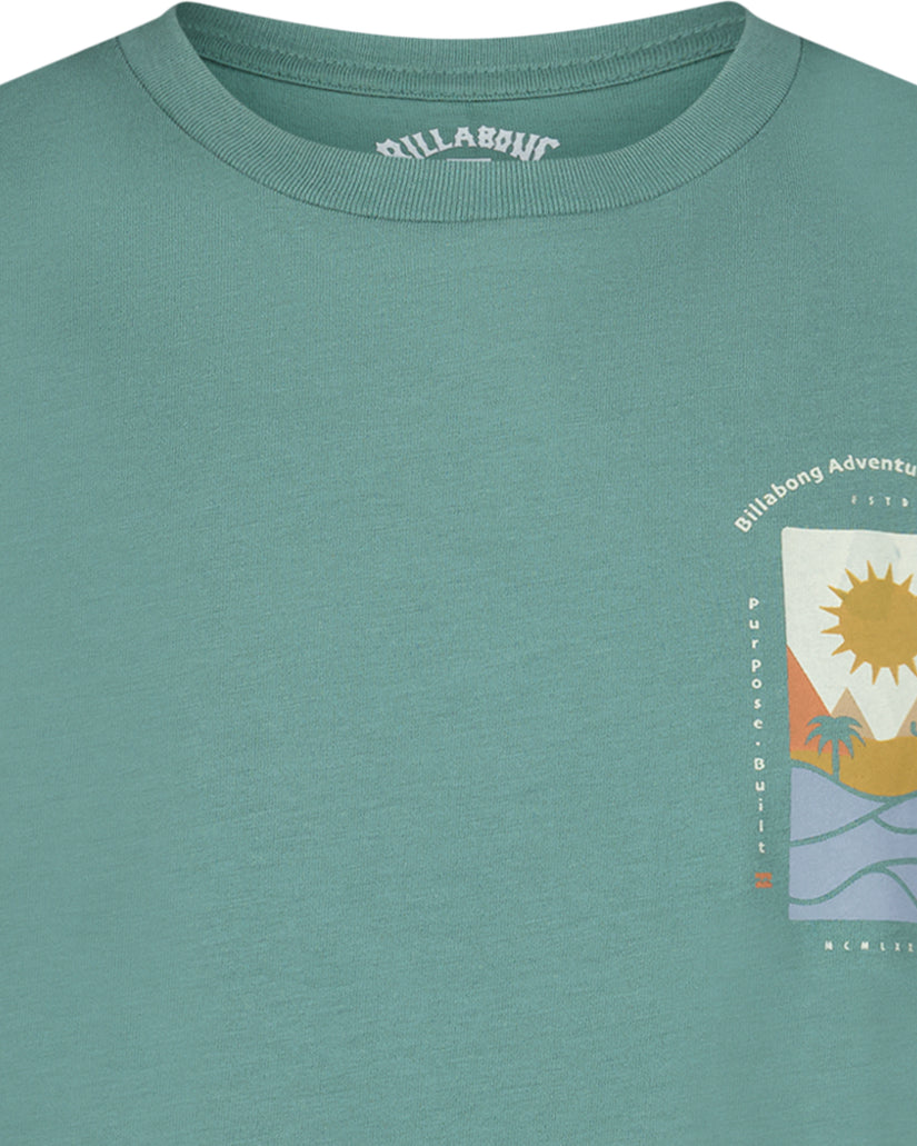 Sage green short-sleeve t-shirt with Billabong Adventure graphic featuring sun, palm tree, and wave design on chest.