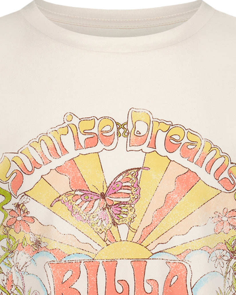 Cream oversized t-shirt with "Sunrise Dreams" text, butterfly, and sun graphic in yellow, pink, and coral tones.