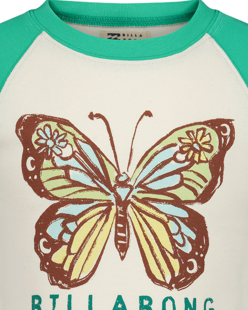 Green and cream raglan t-shirt with brown, yellow, and blue butterfly stamp graphic and "BILLABONG" text.