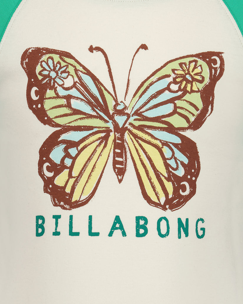 Cream t-shirt with brown, yellow, and blue butterfly stamp print and "BILLABONG" text below.